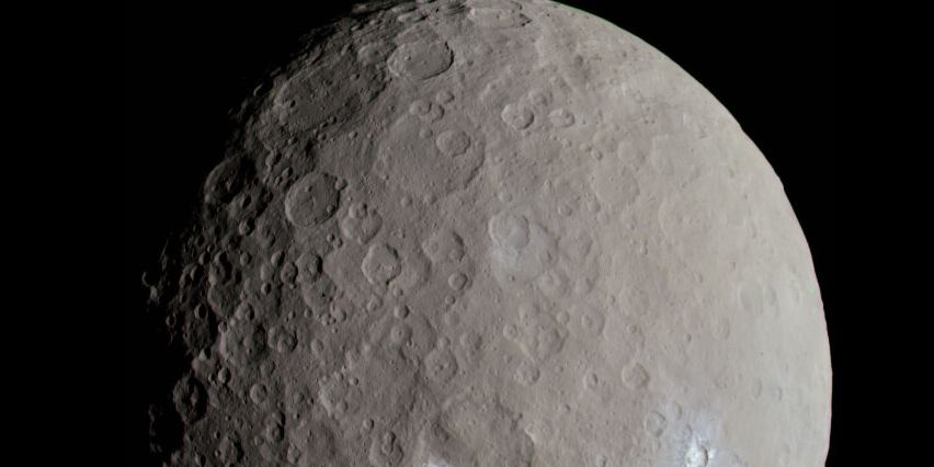 The dwarf planet Ceres, a grey cratered sphere