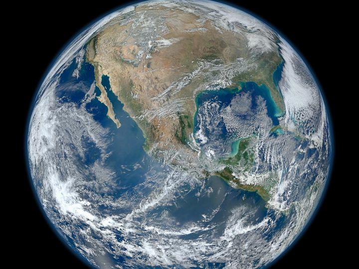 Earth's western hemisphere showing North America, blue oceans and swirling white clouds