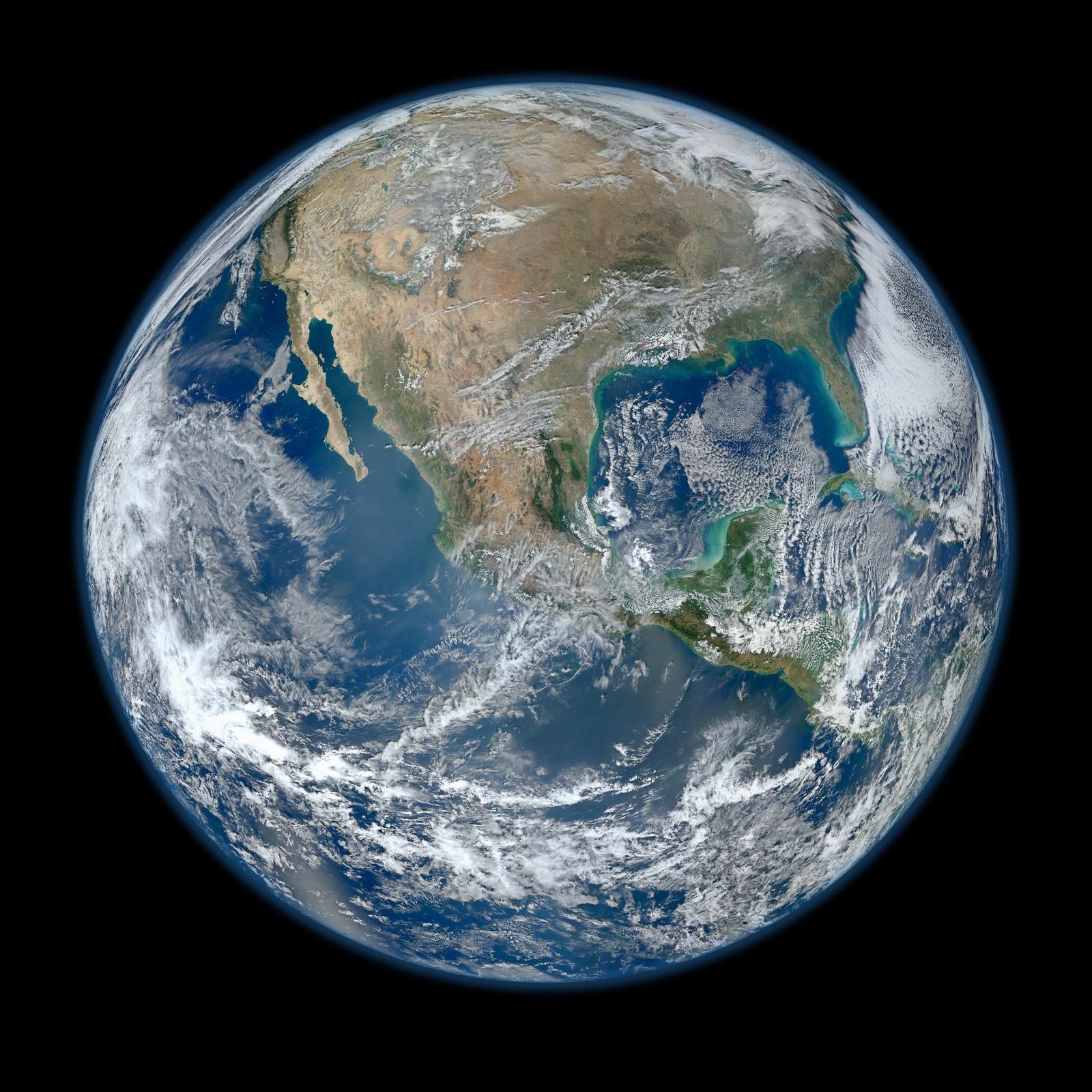 Earth's western hemisphere showing North America, blue oceans and swirling white clouds