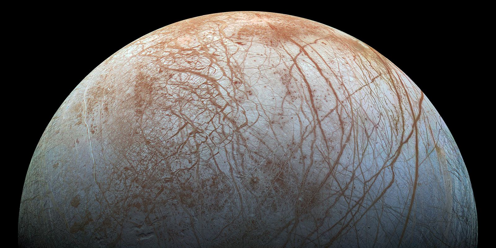 Europa's cracked white and reddish-brown icy surface