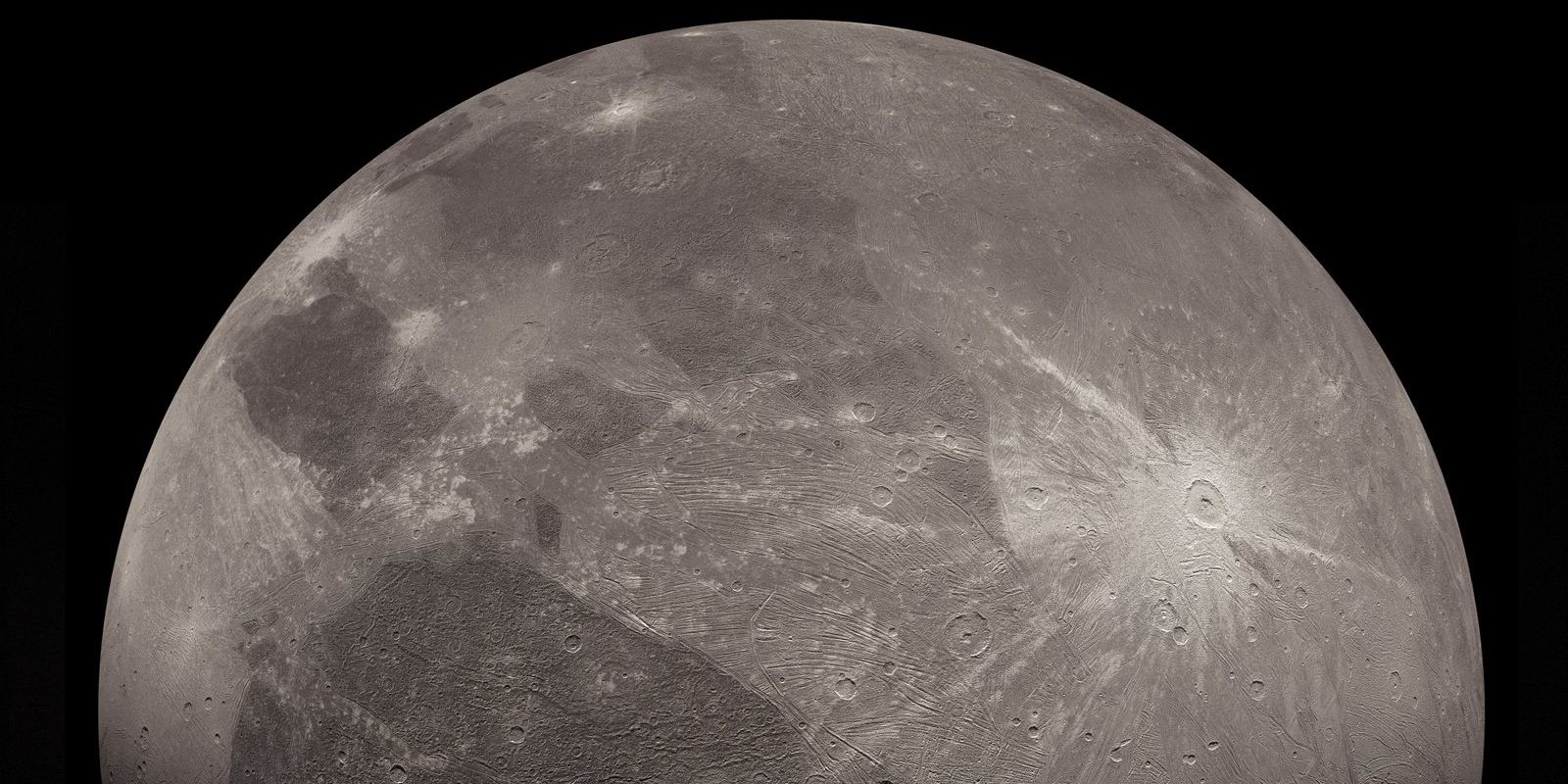 Grey and brown terrain of Ganymede photographed by the Juno spacecraft
