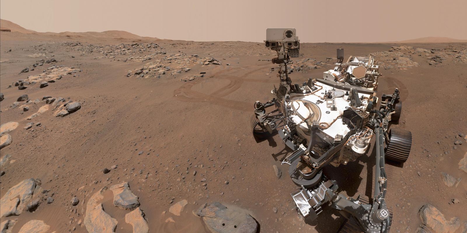 The Perseverance rover taking a selfie next to a rock on Mars