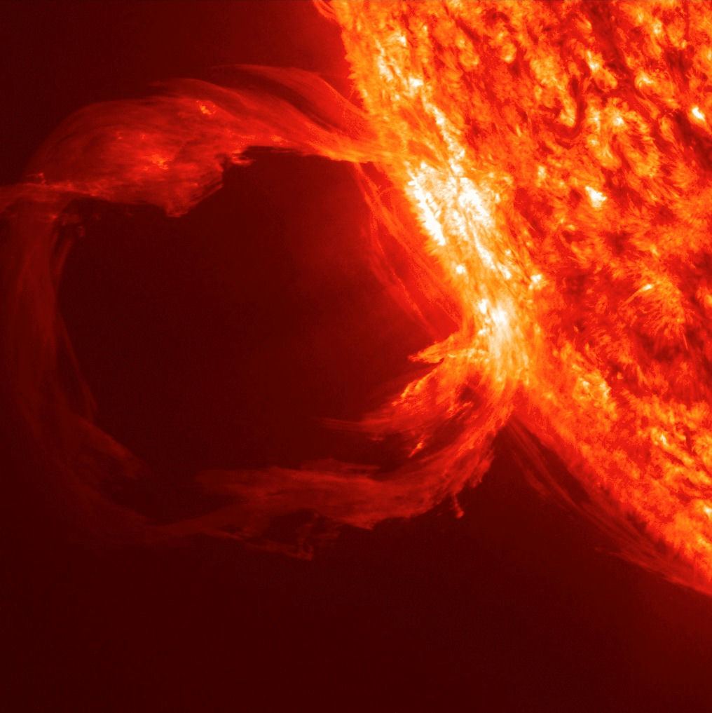 A huge loop of glowing solar plasma lifting off the edge of the Sun